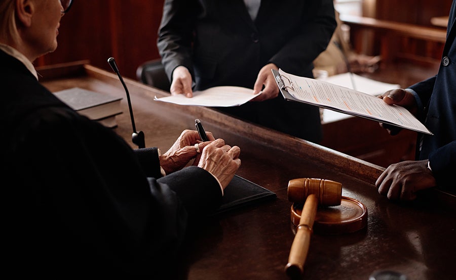 A judge discussing with two attorneys