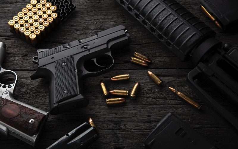 A collection of firearms ,handguns, rifle, and loose bullets